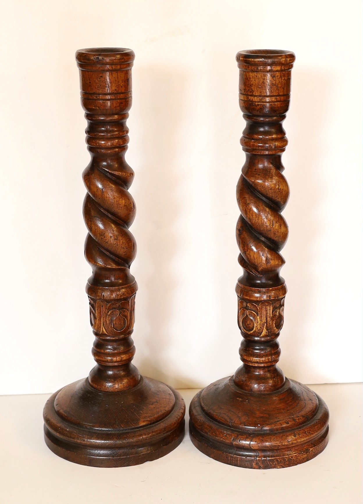 A pair of carved wood barley twist candlesticks, height 46cm